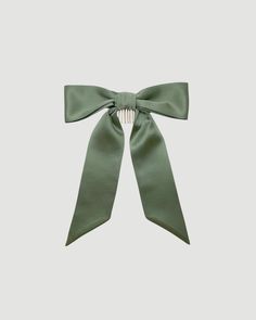 The Gigi & Olive original classic bow now in sage green. This beautiful bow is made from 100% mulberry silk. Sewn together in a perfect bow and fitted with a metal clip so you can easily slide it into your hair, whether it's down or up this is the perfect day-to-night or wedding hair accessory. This bow also has the option for beautiful embroidery on either end. Details: Approx bow loop width - 19cm, Bow height - 24cm, Tail height - 22cm 100% mulberry silk sage green If you choose embroidery, please note we cannot accept returns. Bride Sign, Perfect Bow, Sage Wedding, Green Accessories, Silk Bow, Green Bows, Anne Of Green Gables, Green Gables, Beautiful Embroidery