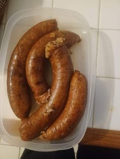 there are three sausages in a plastic container