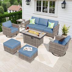 an outdoor patio furniture set with blue cushions