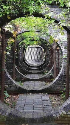 a brick tunnel with trees growing out of it