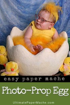 a baby is sitting in an egg with stuffed animals around it and the text easy paper mache photo - prop egg