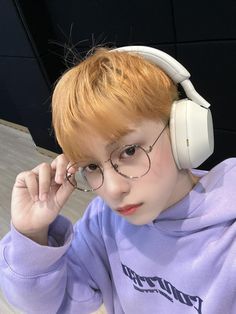 a young boy wearing headphones while sitting at a table