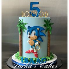 a blue and white birthday cake with sonic the hedgehog on top