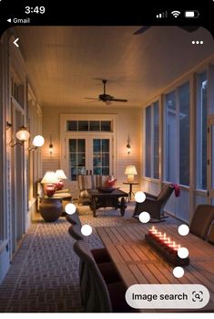 a room that has some lights on the table and chairs in front of it with candles