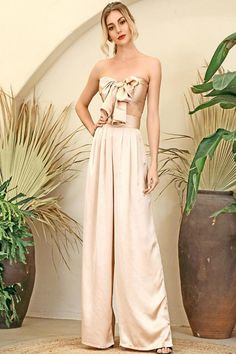 Silky Strapless Tie Front High Waisted Wide Leg Nude Two Piece Pants Set Make a bold statement! Perfect for a night out on the town in this two-piece pant set offers super chick style, Featuring wide-leg pants and a bandeau crop top. A strapless tie front bandeau crop top bow knots in the center, that lets you show plenty of skin and a pair of matching high waist palazzo pants with wide legs that create a gorgeous silhouette. Pair it with strappy heels for a great head-to-toe look! High waist pa Glamorous Strapless Jumpsuit For Spring Evening, Glamorous Spring Evening Strapless Jumpsuit, Chic Two-piece Pantsuit For Party, Chic Two-piece Wide Leg Jumpsuits And Rompers, Chic Two-piece Pantsuit For Night Out, Chic Two-piece Jumpsuit And Romper Set For Spring, Chic Two-piece Jumpsuit For Night Out, Chic Two-piece Jumpsuit And Rompers For Spring, Chic Bottoms For Summer Evenings