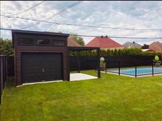 a backyard with a swimming pool and fenced in area next to the yard is shown