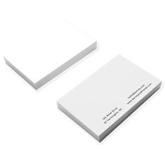 two white business cards sitting on top of each other