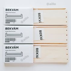 three boxes of bekvam sit next to each other on a white surface