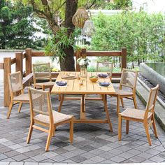 a wooden table and chairs on a patio