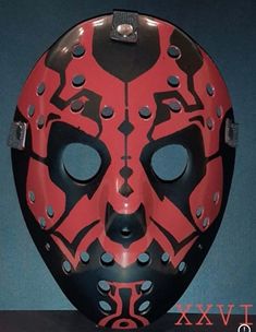 a red mask with black and white designs on it