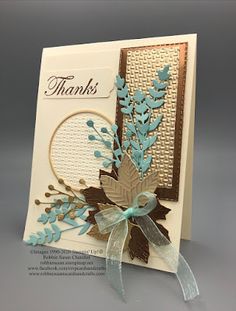 a handmade thank card with blue flowers and leaves on the front, in white paper