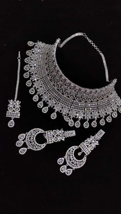 Designer elegant Cubic zirconia necklace set .  This necklace is a perfect example of High Quality handwork . > Premium quality CZ stones  were used in this necklace. Inspired By Sabyasachi Wedding jewelry . Such intricate detailing in this Inspired Heritage Royal Set with american diamond work. This set will surely make heads turn .. Wedding jewelry , wedding necklace , bridal collection , bridal necklace , engagement jewelry , bridal shower jewelry . Heavy Diamond Necklace For Celebrations, Traditional Silver Jewelry With Sparkling Stones, Traditional Necklaces With Sparkling Cubic Zirconia, Festive Cubic Zirconia Necklaces Hand Set, Round American Diamond Necklaces With Stone Work, Traditional Diamond Necklaces With Sparkling Stones, Traditional Necklaces With Sparkling Stones For Celebration, Dazzling Silver Jewelry With Stone Work, Traditional Bridal Necklace With Sparkling Stones As A Gift