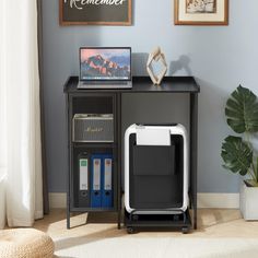 a computer desk with a laptop and printer on it