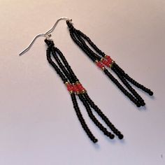 These earrings are the perfect mix of simple and sleek. The three strands are mostly black with gold detail and a red center.  Due to the light weight, this will move with your movement (without a tickle). Elegant Black Earrings With Tiny Beads, Elegant Black Beaded Earrings With Tiny Beads, Black Earrings With Tiny Round Beads, Fringe Bead Earrings, Long Fringe, Long Fringes, Teardrop Beads, Fringe Earrings, Bead Earrings