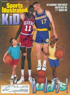 an autographed magazine cover with two basketball players and one kid holding a ball