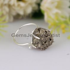 Raw Druze Pyrite Gemstone Ring - 925 Sterling Silver Ring - Adjustable Silver Ring - Unique Prong Setting Pyrite Ring Gift for Anniversary. Product Details-  Main Stone Name- Druzy Pyrite Main Stone Shape-  Rough Metal- 925 Sterling Silver  Stamped- 925  ► T H E Q U A L I T Y We use the finest quality and polished gemstones to make high quality, safe and durable jewelry. As these are natural gemstones which are not all exactly the same so there can be slight inclusions and color variations. They are most of raw rough gemstones so the color, shape and size may vary from the actual picture. You need to keep away the products from chemicals, perfumes , water and other similar substances that will help you preserve their beauty and longevity, store your jewelry in a dry place. ►C U S T O M E Silver Gemstone Rings For Jewelry Making, Silver Toe Ring With Prong Setting, Minimalist Silver Diamond Ring With Gemstone, Silver Sterling Cluster Ring With Gemstones, Silver Sterling Silver Cluster Ring With Gemstone, Adjustable Silver Cluster Ring, Sterling Silver Cluster Ring With Gemstone, Silver Diamond Ring With Gemstone, Adjustable, Unique Sterling Silver Cluster Ring With Gemstones