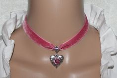 Dirndl choker with a lovingly decorated heart made of high-quality pewter and hand-glued metal rose. All metal parts are galvanized on old silver. The color of the velvet ribbon is pink. Stainless steel lobster clasp and chain extension for individual length. This noble choker enhances any dirndl or traditional dress, ideal for the Oktoberfest, for traditional festivities but also for other occasions. Pink Heart-shaped Choker As A Gift, Pink Heart Choker As Gift, Pink Heart-shaped Choker For Gifts, Pink Heart-shaped Choker Gift, Pink Heart-shaped Choker For Valentine's Day, Pink Metal Choker For Party, Heart With Rose, Choker Jewellery, Visual Archive