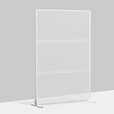 a white pegboard with three holes on it