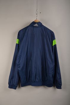 "Vintage Adidas 90s windbreaker is in great condition without stains or holes. Size: m( to be sure check the measurement ) Material: 100% NYLON MADE IN LAO Measurement: - Chest(armpit to armpit: 62cm(24.4\") - Length from the backside(Center bottom of the collar to center bottom of the garment): 69cm(27.1\") - Shoulder to shoulder seam:61cm(24..\") - Shoulder seam to end of cuff:60cm(23.6\") NOTE: Because of the age, clothing can shrink or the sizing from that time wasn't the same as the size fr Sportswear Nylon Track Jacket With Adidas Logo, Adidas Track Jacket For Training, Adidas Sportswear Track Jacket For Training, Adidas Nylon Track Jacket, Adidas Nylon Track Jacket For Sports, Adidas Athleisure Track Jacket For Training, Sporty Nylon Track Jacket With Adidas Logo, Nylon Track Jacket With Three Stripes For Sports, Adidas Long Sleeve Nylon Track Jacket