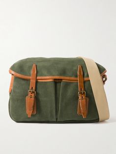 Bleu de Chauffe's messenger bag is modelled on a traditional fisherman's musette. Made at the brand's workshop in France, it's crafted from smooth green suede with brown leather buckle fastenings and a durable canvas strap. It opens up to a spacious compartment that's fitted with a zip pocket to keep your phone or cardholder secure. Luxury Green Canvas Shoulder Bag, Luxury Green Shoulder Bag With Leather Trim, Green Leather Trim Crossbody Shoulder Bag, Green Satchel Bag With Leather Trim, Green Leather Shoulder Bag With Leather Trim, Green Leather Bag With Leather Trim, Green Leather Bags With Leather Trim, Green Satchel Shoulder Bag With Waxed Finish, Green Waxed Finish Satchel Shoulder Bag