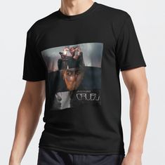 a man wearing a black t - shirt with an image of a woman's face on it