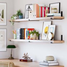 two shelves with books and pictures on them