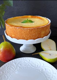 a cake on a plate next to an apple