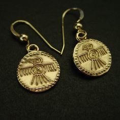 "Hand carved tiny quetzal art bird earrings symbol of the Aztec god Quetzalcoatl. The quetzal is a rare paradisiac colorful bird of Mesoamerica. In the worldview of the Mayan and Aztec cultures, the quetzal occupied a very important place. This beautifully plumaged bird symbolized the feathered serpent, the great god Quetzalcóatl or Kukulkán, who was in charge of protecting heaven and earth. With its serpent form, but crowned with quetzal feathers, Quetzalcóatl was the god of the air. He's a deity that appears repeatedly as a symbol in the pyramids and representations of both cultures. Today the quetzal is the national bird of Guatemala, and their national currency has been named after it.  - Hand carved earrings. - Solid yellow bronze also called jeweler gold bronze charms. - 1/5\" charms Symbolic Ceremonial Jewelry Nickel Free, Nickel Free Symbolic Ceremonial Jewelry, Ceremonial Symbolic Nickel-free Jewelry, Nickel Free Symbolic Jewelry For Ceremonial Occasions, Gold Round Jewelry With Bird Design, Mesoamerican Jewelry, Mayan Earrings, Quetzal Art, Aztec God Quetzalcoatl