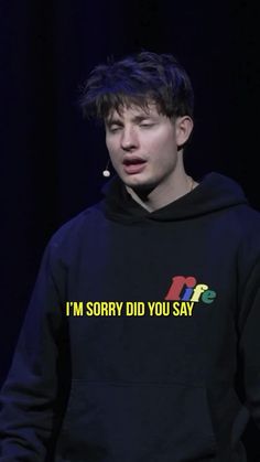 a young man wearing a black hoodie that says i'm sorry did you say?