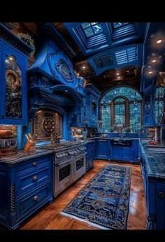 a large kitchen with blue cabinets and wooden floors