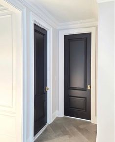 an empty room with two black doors in it