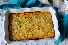 a casserole dish with broccoli and cheese in it on a table