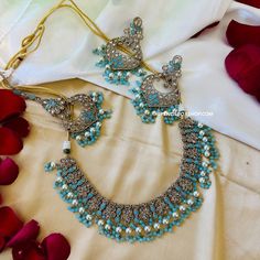 Aarohi Firozi Sky Blue Golden Polki Necklace Set with maangtikka. Expertly crafted, the Aarohi Firozi Sky Blue Golden Polki Necklace Set with maangtikka features exquisite detailing and elegance. The sky blue and golden tones complement each other, creating a stunning piece perfect for any occasion. Elevate your look with this timeless set. Turquoise Stone Work Jewelry For Wedding, Festive Blue Kundan Necklace With Intricate Design, Blue Kundan Necklace With Intricate Design For Festive Occasions, Turquoise Jewelry With Stone Work For Wedding, Traditional Turquoise Jewelry Sets For Wedding, Festive Turquoise Bridal Necklace For Wedding, Festive Turquoise Bridal Necklace, Festive Turquoise Kundan Necklace For Wedding, Blue Kundan Necklace For Diwali Wedding