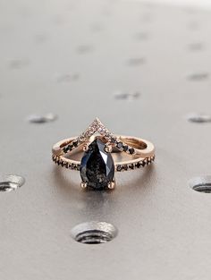 a black diamond ring sitting on top of a table