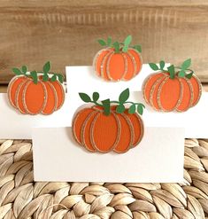 three orange pumpkins are sitting on top of a card