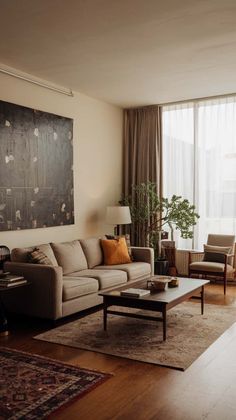 a living room filled with furniture and a large painting hanging on the wall above it