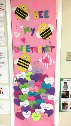 a door decorated with paper hearts and bee my shelterer written on the front side