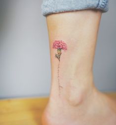 a small pink flower on the ankle