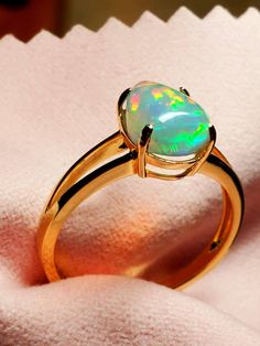 14k solid gold opal ring, beautiful opal with many bright rainbows adorning it mounted on a gold split shank ring. The ring is light and easy to wear and comes in 6 sizes I can swap the stone into. Gold Ethiopian Opal Ring Hallmarked, Formal Yellow Gold Ethiopian Opal Ring, Gold Ethiopian Opal Ring For Anniversary, Elegant Ethiopian Opal Ring, Hallmarked, Elegant Hallmarked Ethiopian Opal Ring, 14k Yellow Gold Opal Promise Ring, Elegant Hallmarked Opal Ring, Gold Ethiopian Opal Ring Fine Jewelry, Yellow Gold Opal Ring In Fine Jewelry Style