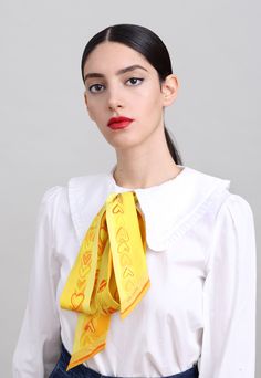 This skinny printed silk scarf is all you need in order to add elegance and color to your wardrobe. Crafted in Italy from beautiful twill silk according to an original design by Dikla Levsky, this narrow scarf is a super versatile. Whether worn around your neck, on your wrist or looped around your waist, its long and narrow shape offers effortless style. This piece has two complementary sides, both in beautiful yellow and orange shades and sweet printed hearts. Colors: shades of yellow and orang Gold Silk Scarf For Spring, Formal Scarf Neckwear, Elegant Yellow Silk Scarf, Classic Silk Scarf For Spring Gift, Elegant Gold Scarves For Spring, Elegant Yellow Silk Scarf Gift, Elegant Yellow Summer Scarf, Yellow Silk Scarf For Gift, Yellow Silk Scarf For Summer