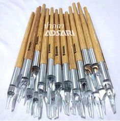 eight wooden crochet hooks are lined up next to each other