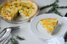 a slice of quiche on a plate next to the pie