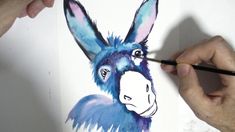 someone is drawing a donkey with colored pencils and watercolor paints on white paper