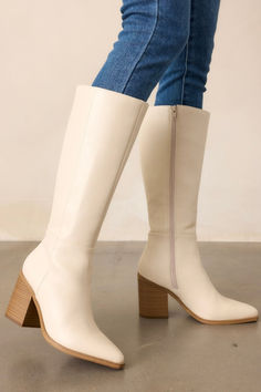 Elevate your style with these luxurious Sapphire Twilight Ivory Knee High Boots. These boots offer comfort and sophistication. The delicate shimmer of the sapphire details adds a touch of elegance to any outfit. Take on the day with confidence and beauty in these knee-high boots. These ivory boots feature a pointed toe, a sleek faux leather ivory material, a brown block heel, a functional side zipper, a knee high design and a brown sole. Ivory Boots, Timeless Boots, Brown Block Heels, Sorority Rush Dresses, Preppy Girls, Corporate Chic, Rush Dresses, High Design, Women's Shapewear