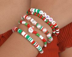 the bracelets are decorated with candy canes and snowman beads on each arm