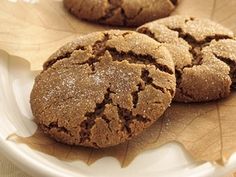 two cookies are on a plate with leaves