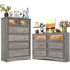 two wooden dressers with flowers and pictures on top, one in grey wood the other in gold