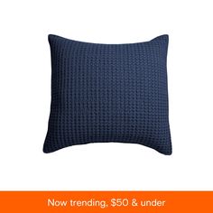 a blue pillow with the words now trending $ 50 & under