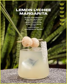 the lemon lychee margarita is served in a tall glass with ice and garnishes