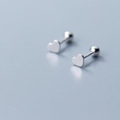 So tiny and oh-so-sweet! These mini stud earrings are the perfect addition to your minimalist earring collection. Simple heart shapes made of 925 Sterling Silver with screw on ear backings. Please note: This is a final sale item and no returns or exchanges are accepted for this item. Product requires extended processing and shipping time. Minimalist Hypoallergenic Heart-shaped Piercings, Minimalist Hypoallergenic Heart Piercings, Minimalist Hypoallergenic Heart Piercing, Hypoallergenic Heart Shaped Minimalist Piercing, Minimalist White Gold Heart Earrings, Tiny Minimalist Heart Earrings, Minimalist White Gold Heart Earrings For Everyday, Bead Fashion, Minimalist Earring